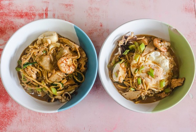 Bowls of seafood Hokkien mee with seafood and soft cooked eggs at Go La / Streets of Food